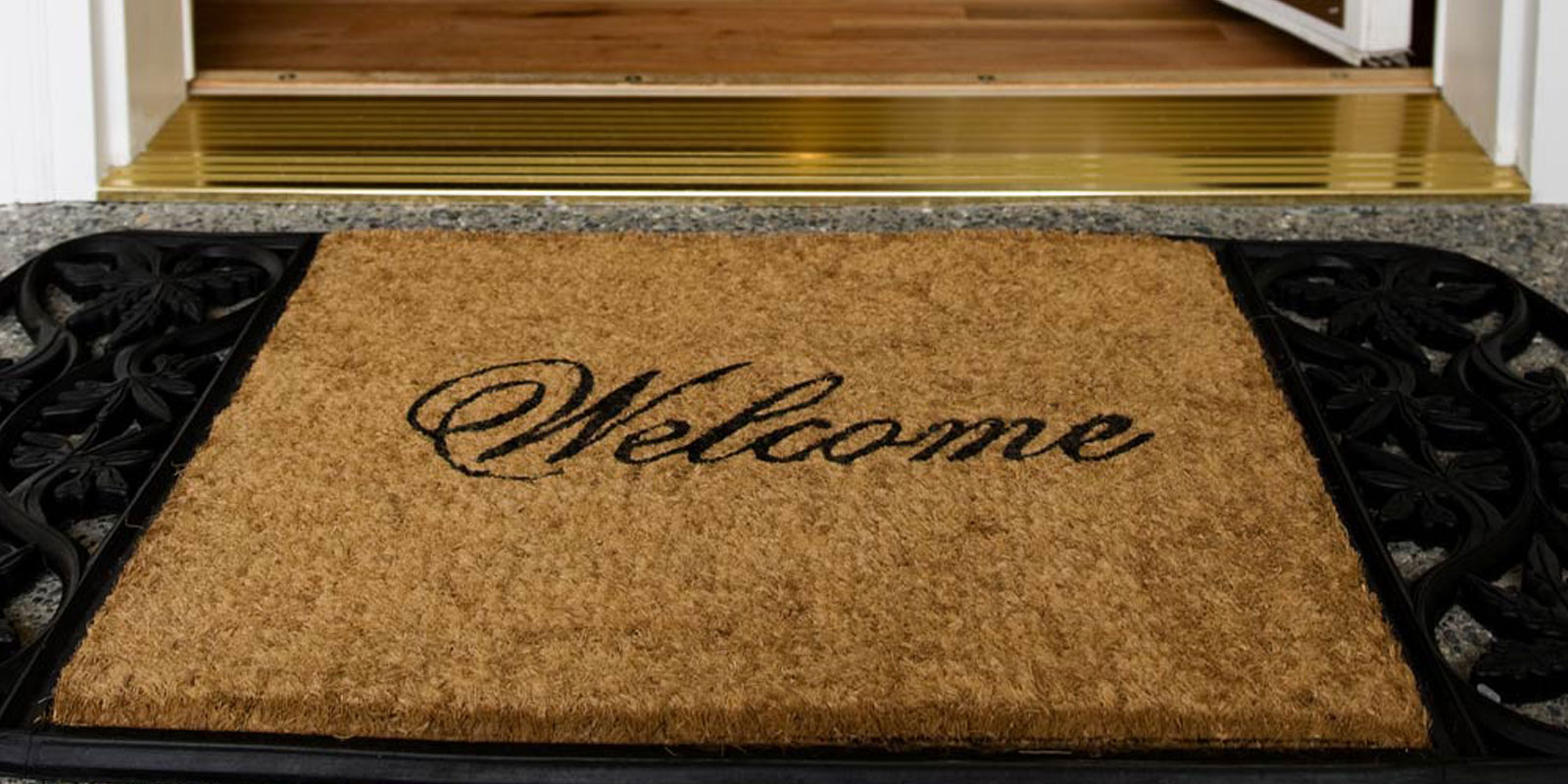 Door mat that says 'Welcome' in cursive